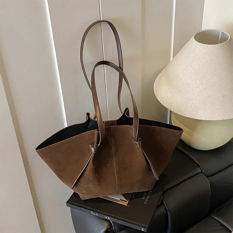Close-up of an elegant faux suede tote handbag for women, highlighting its texture and high-quality material.