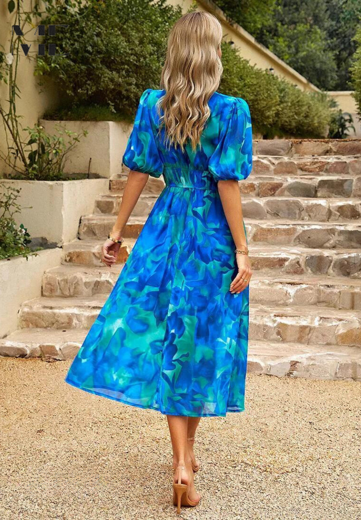 Women's elegant short sleeve midi dress, A-line cut with vibrant floral pattern.