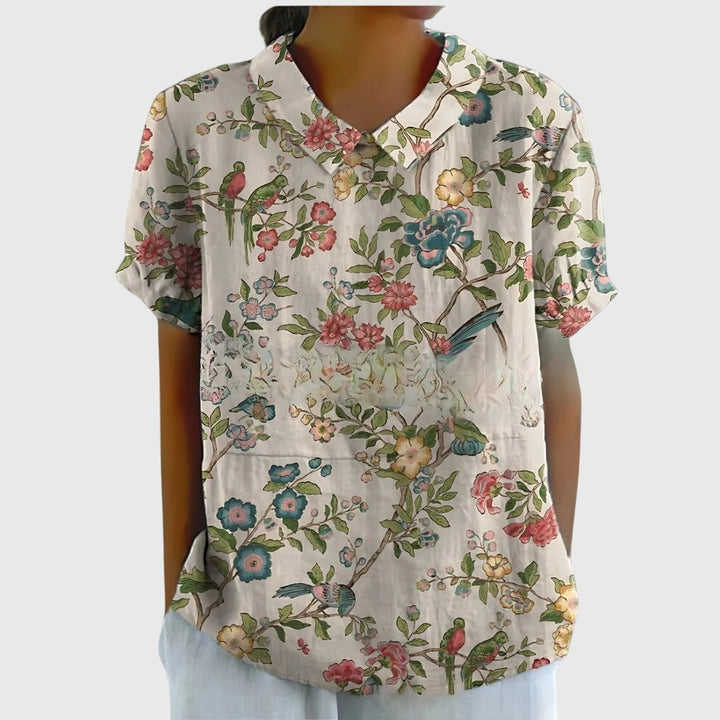 Side profile of a woman in a stylish floral blouse, emphasizing its elegant design and comfortable fit.