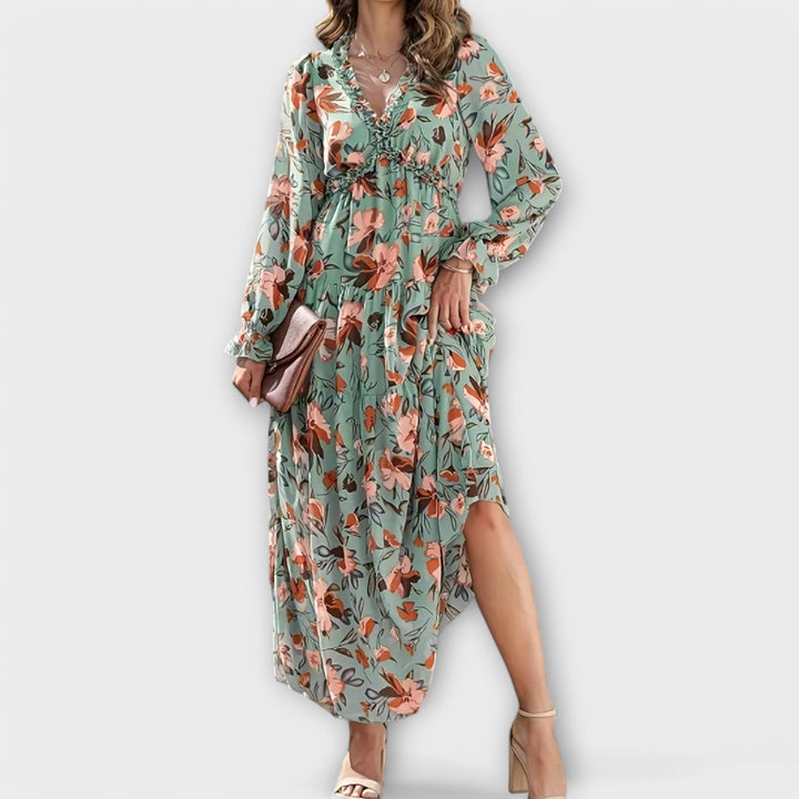 Flowy long maxi dress for women featuring a beautiful floral print and stylish pleats.
