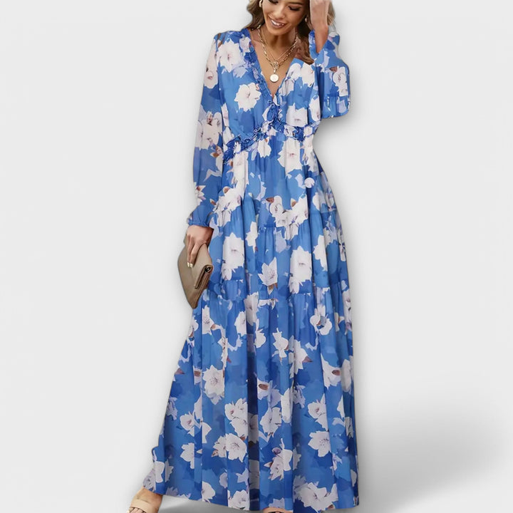 Women's elegant floral print maxi dress with delicate pleats, ideal for sophisticated occasions.