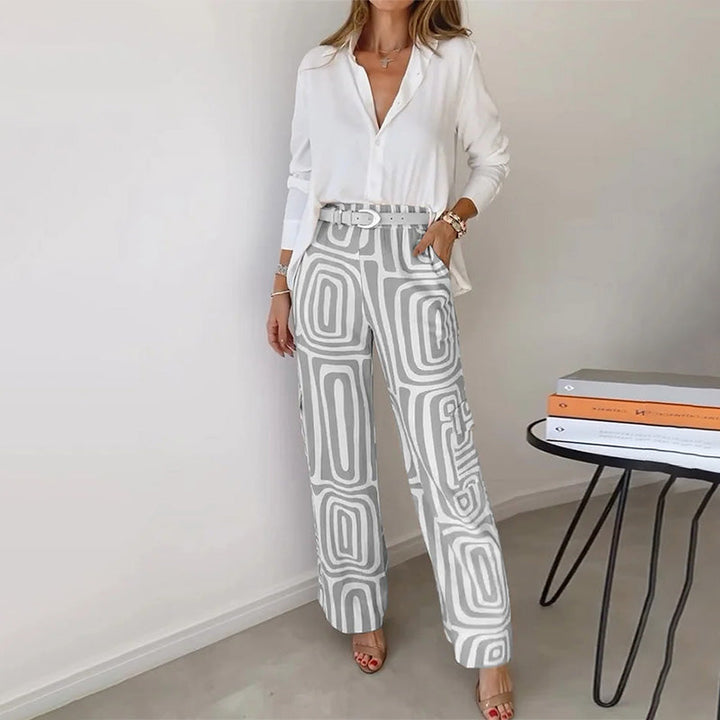 Sophisticated women's fashion two-piece set featuring an elegant flowing top & patterned trousers.
