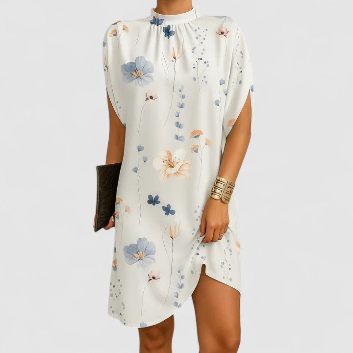 Women's elegant maxi dress with a flowy silhouette and modern shoulder cutouts, ideal for sophisticated events.