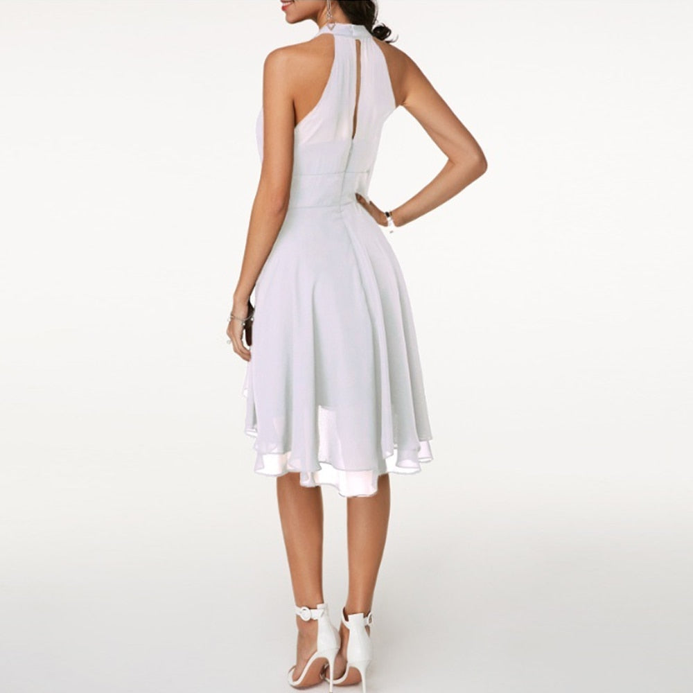 Women's party dress: elegant halter neck mini with a flowing layered hem. Ideal for cocktails or evening events.