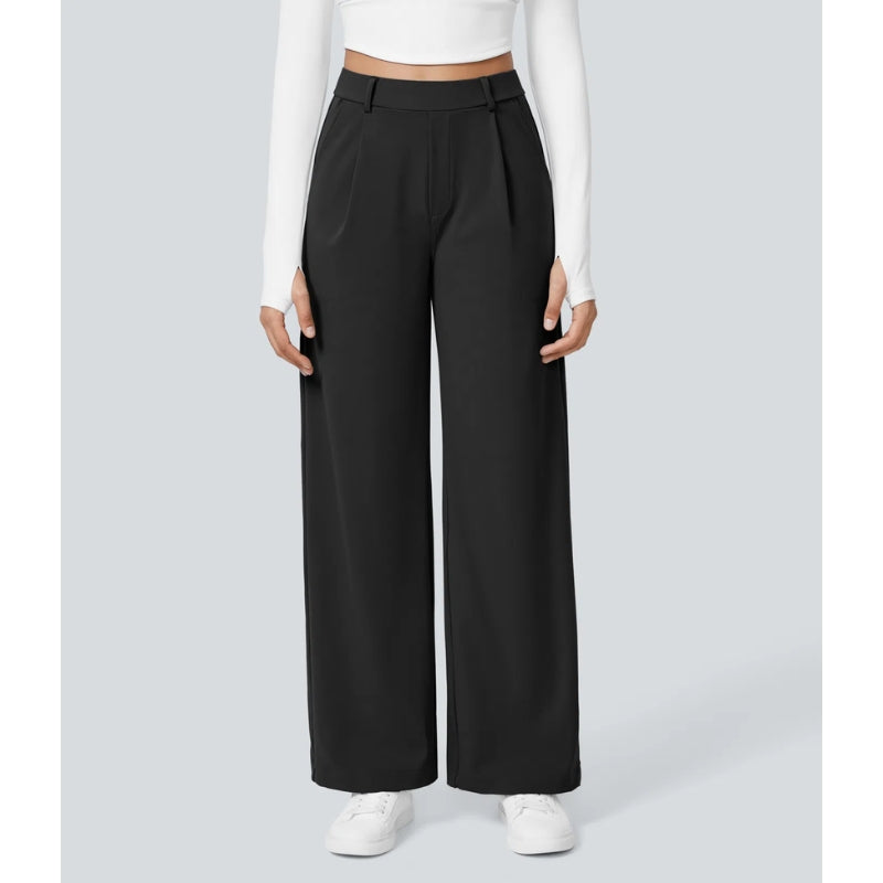 Close-up of the fabric and pleating on women's high waisted wide leg tailored dress pants.