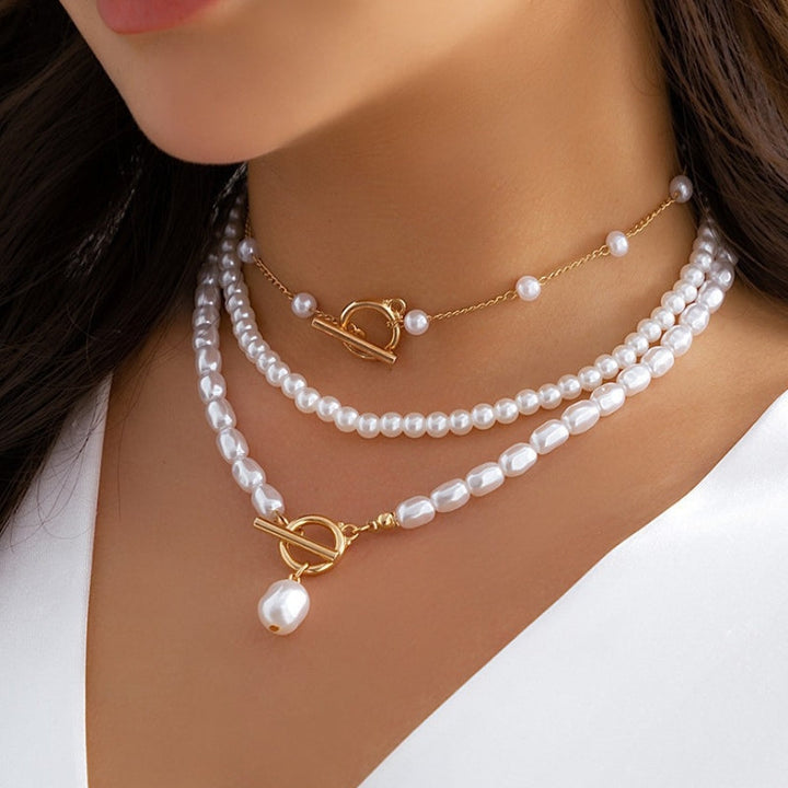 Adjustable women's gold-tone layered necklace with multiple pearl accents, perfect for an elegant fashion accessory.