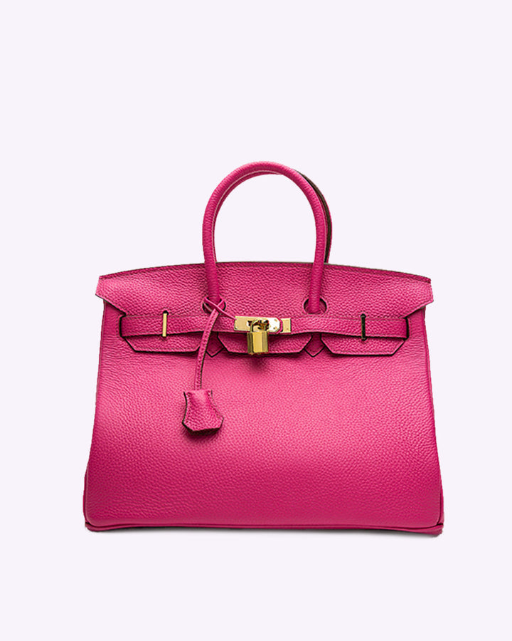 Brown women's elegant leather handbag. Spacious shoulder bag for daily use, a versatile fashion accessory.