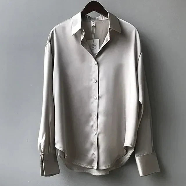 Stylish women's elegant top, a long sleeve button-down satin blouse, ideal for versatile office wear.
