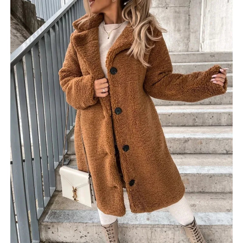 Elegant women's longline faux shearling winter coat, cozy and warm, perfect for cold weather fashion.