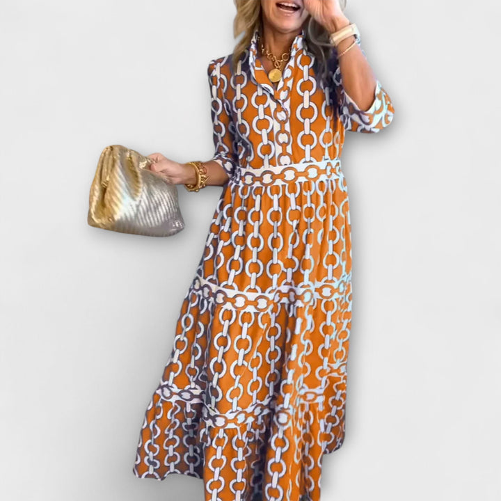 Comfortable women's midi dress featuring a sophisticated chain pattern. An elegant choice for any party.