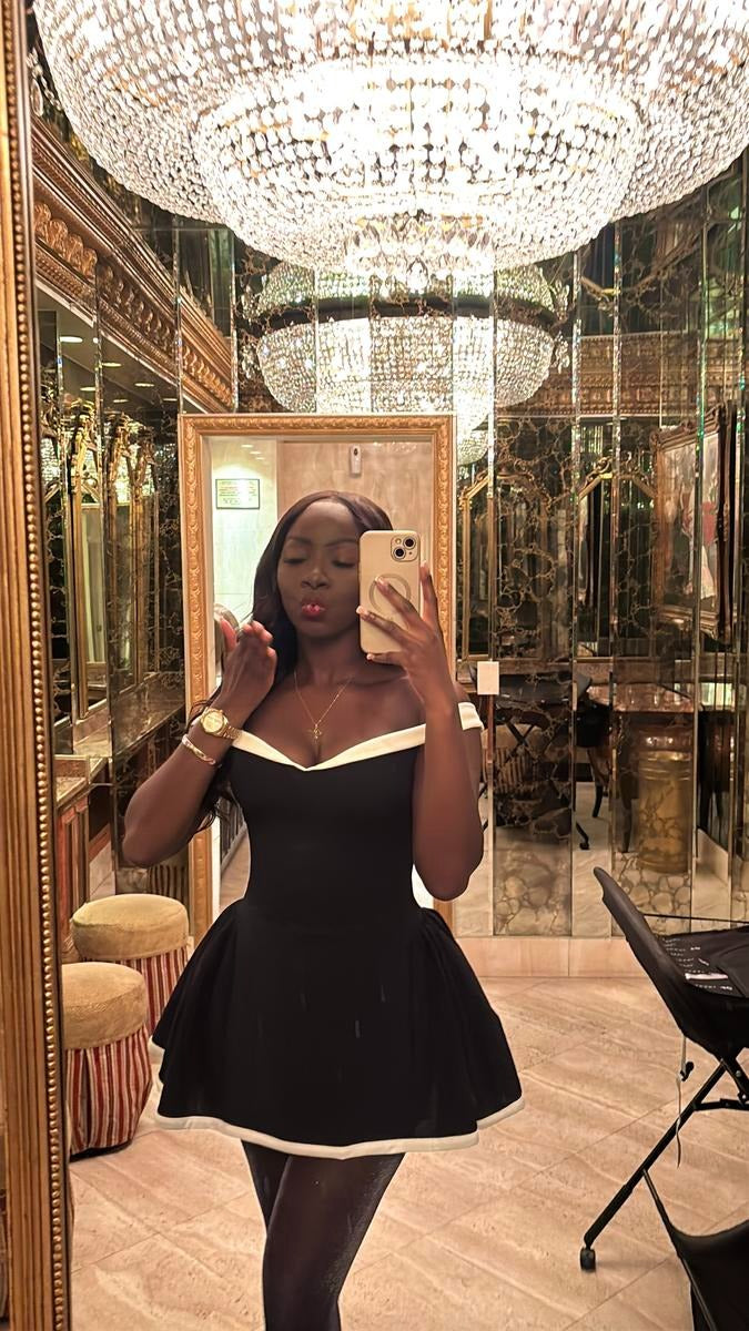 Black mini dress for women featuring a stylish contrast neckline, ideal for elegant occasions
