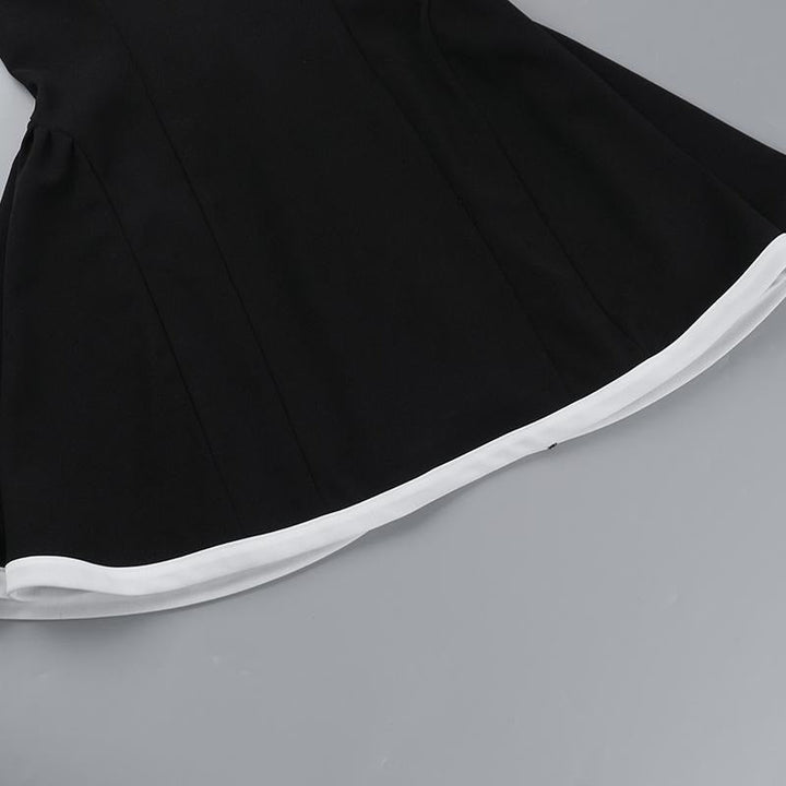 Full-length view of a women's elegant black mini dress with a distinctive contrast neckline