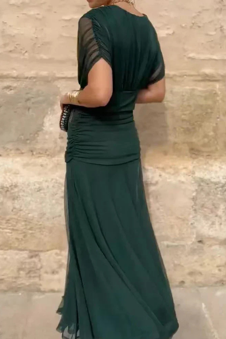 Side profile of the women's off-shoulder ruched midi dress, highlighting its flattering and flowy design.