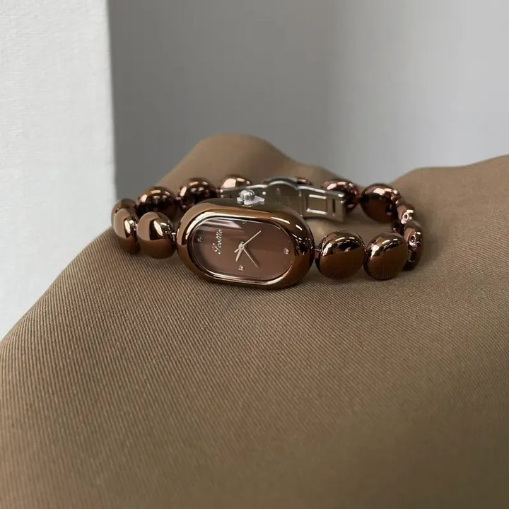 Classic women's stainless steel oval watch featuring a minimalist face and reliable quartz movement.
