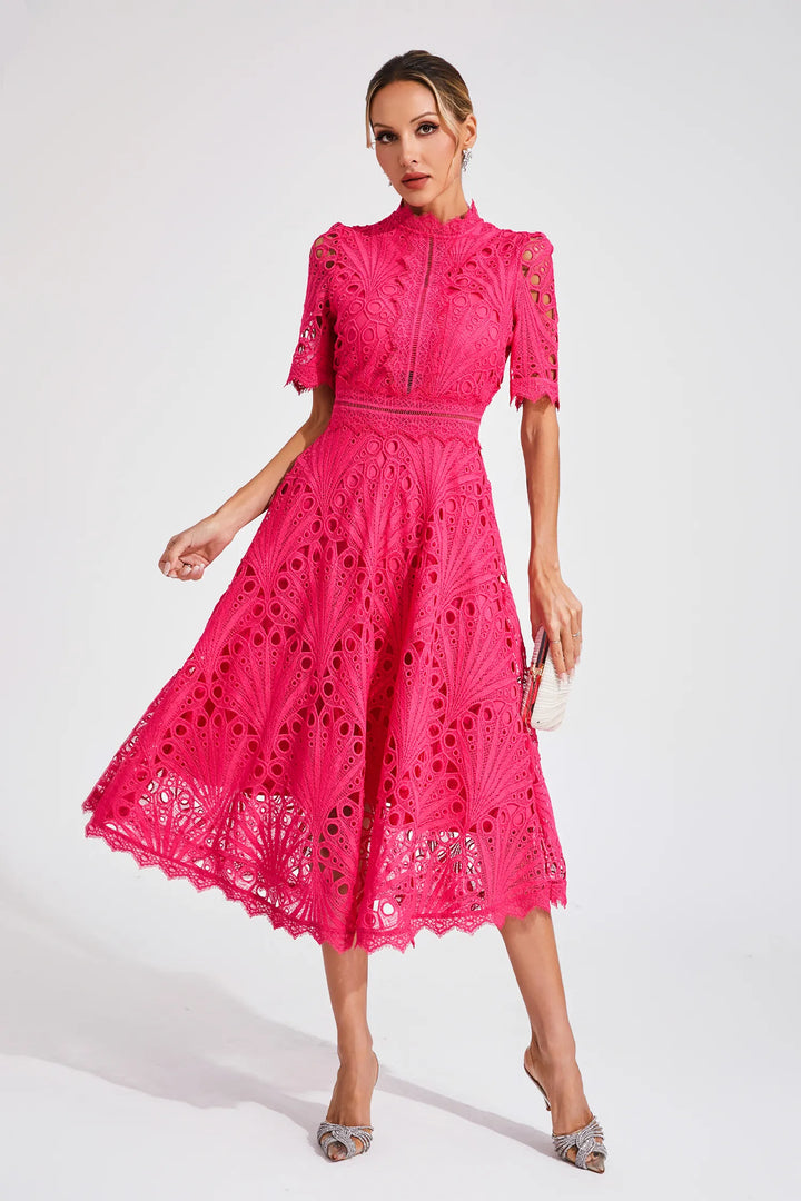 Close-up of the delicate lace pattern on a women's pink midi dress, showcasing elegance