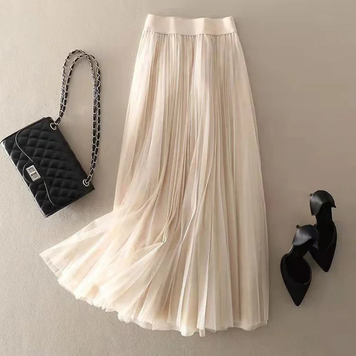 Beautiful women's elegant flowy pleated midi skirt. High-waist design for versatile and comfortable spring/summer style.