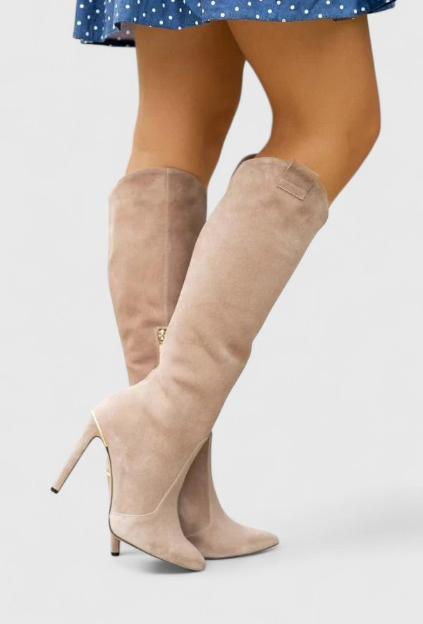 Full shot of women's knee high boots with a sharp pointed toe, ideal for spring outfits