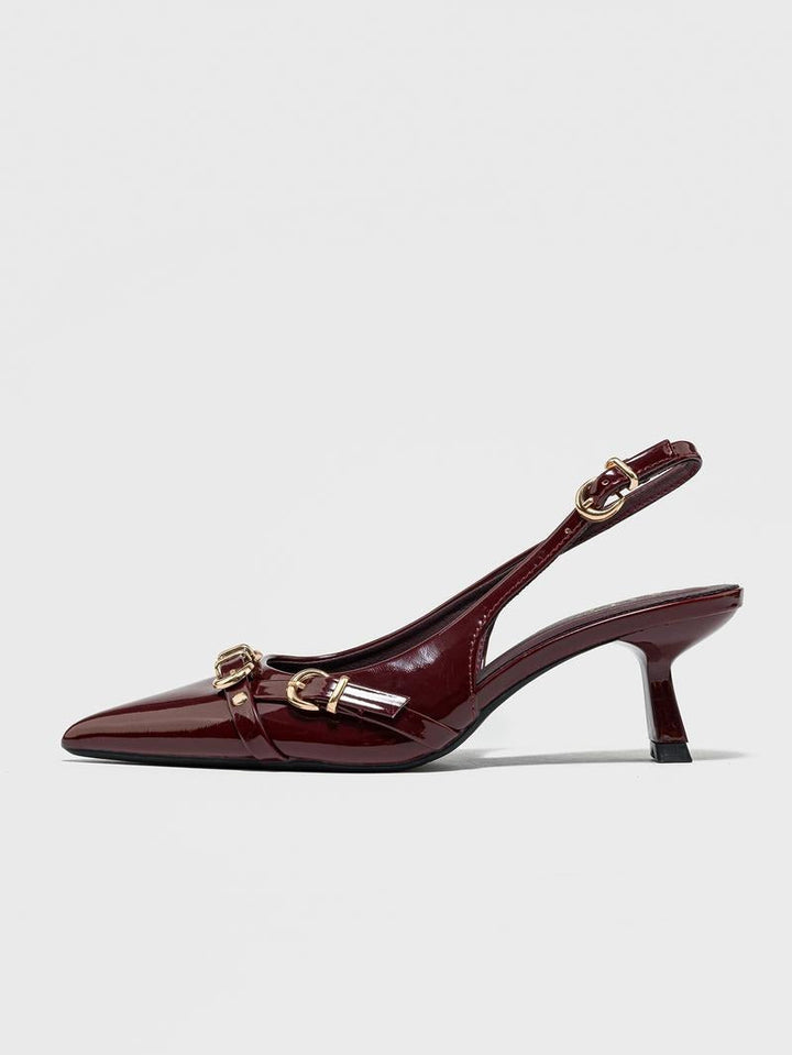 Close-up of a women's patent leather pointed toe heel, showcasing the glossy finish and elegant design