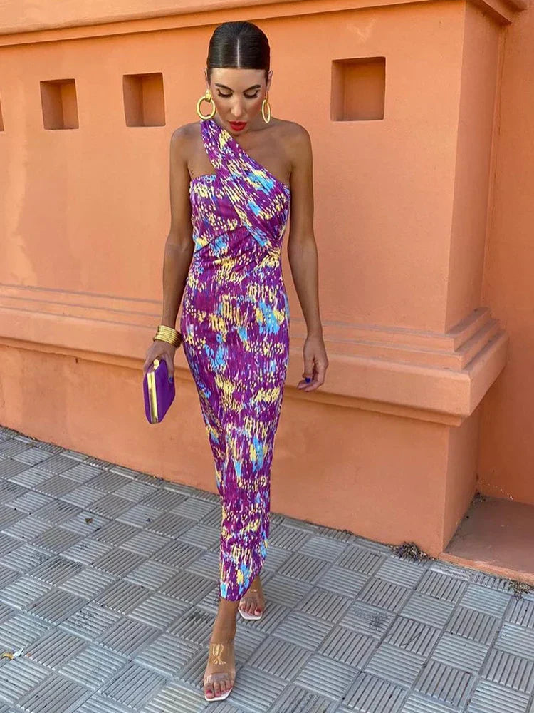 Stylish women's printed maxi dress with a one-shoulder cut, suitable for elegant events.