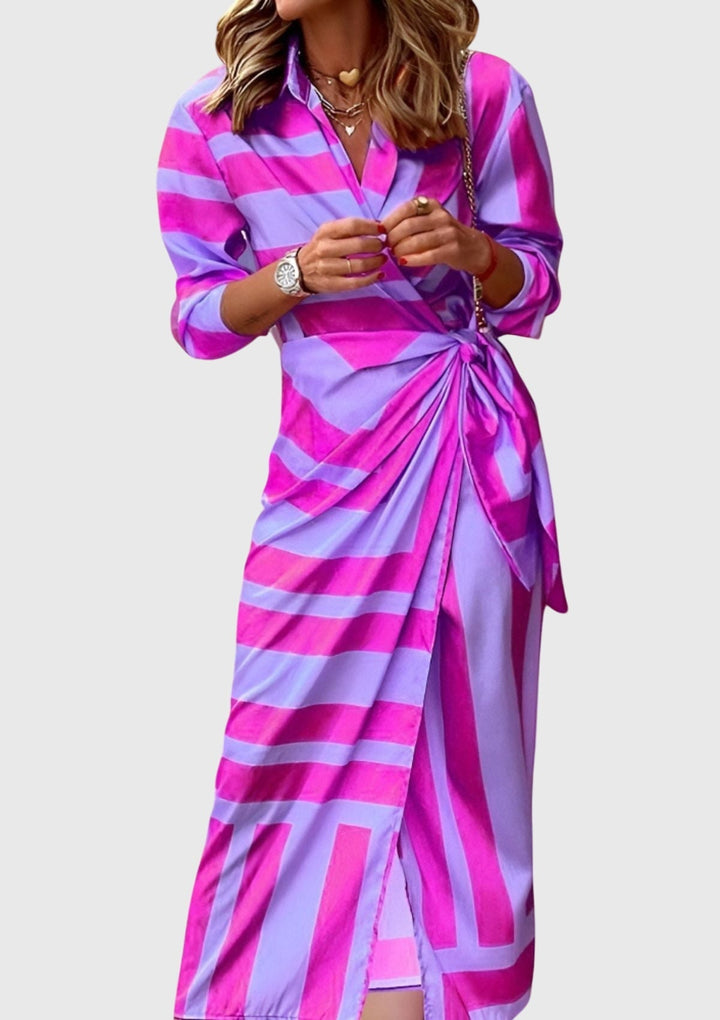Detailed view of the elegant print on a women's flattering wrap dress, perfect for spring/summer.