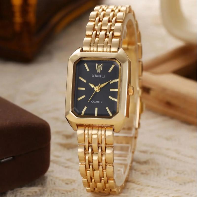 Close-up of a women's gold rectangular quartz watch with a stainless steel band, highlighting the dial.