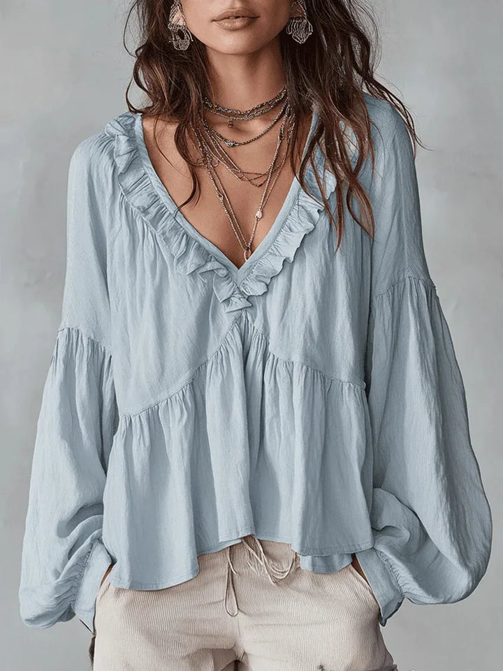Chic long-sleeve ruffle top for women, featuring a flattering V-neck & delicate puff sleeves. Ideal for any occasion.