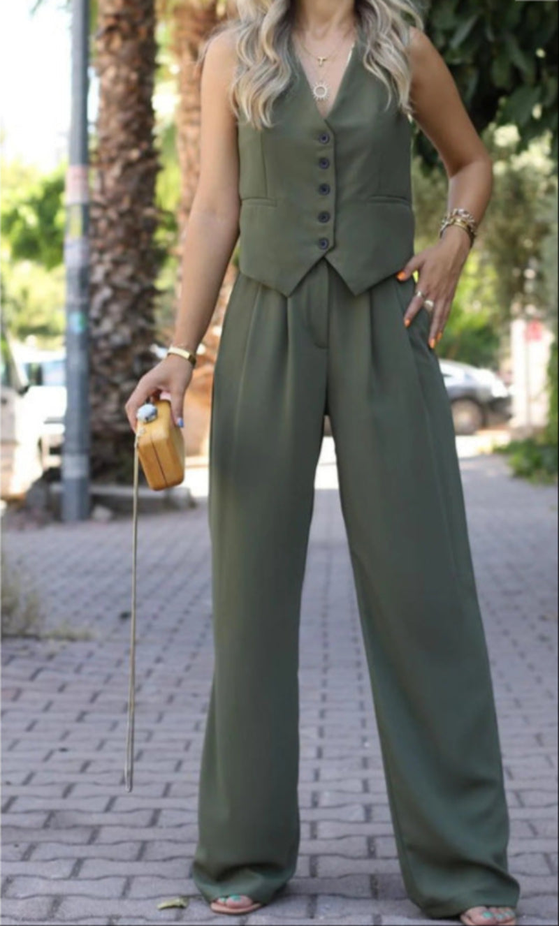 Chic women's sleeveless blazer paired with slim trousers, creating an elegant and versatile suit look.