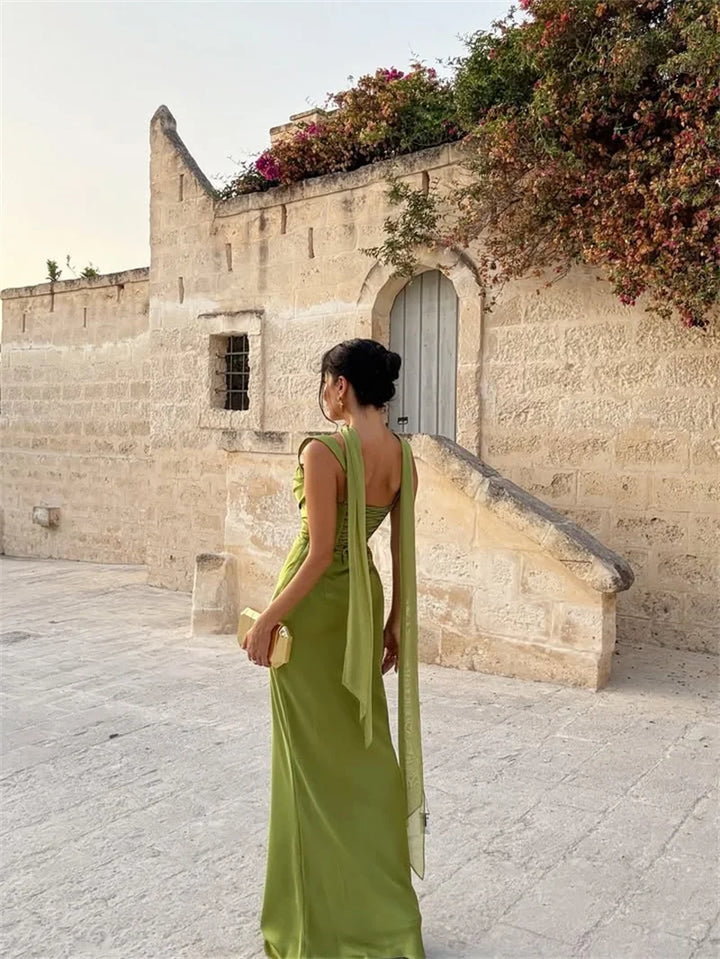 Long sleeveless wedding guest dress with a flowing maxi skirt and delicate details.
