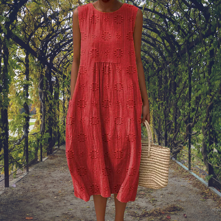 Light & flowy elegant women's sleeveless midi dress for summer. Textured casual day wear with a round neck.