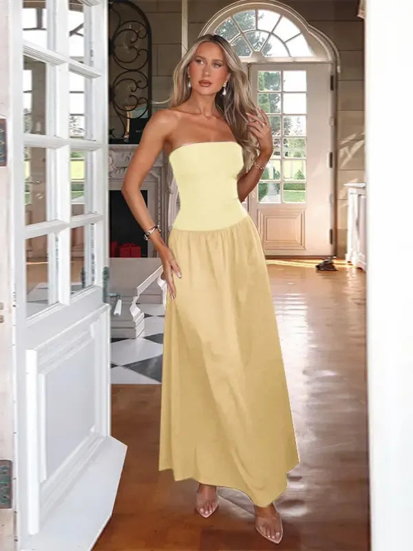 Fashionable women's strapless maxi dress with a long, flowing skirt, suitable for formal occasions.