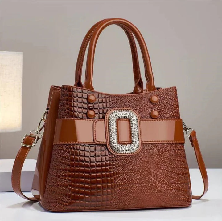 Close-up of a women's textured lizard leather bag, showcasing its exquisite craftsmanship.