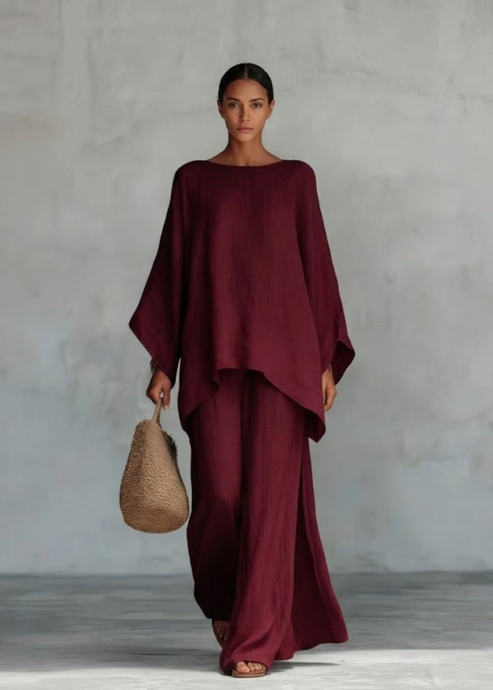 Versatile women's two-piece set, combining a chic cape top and wide-leg pants, perfect for resort or casual wear.