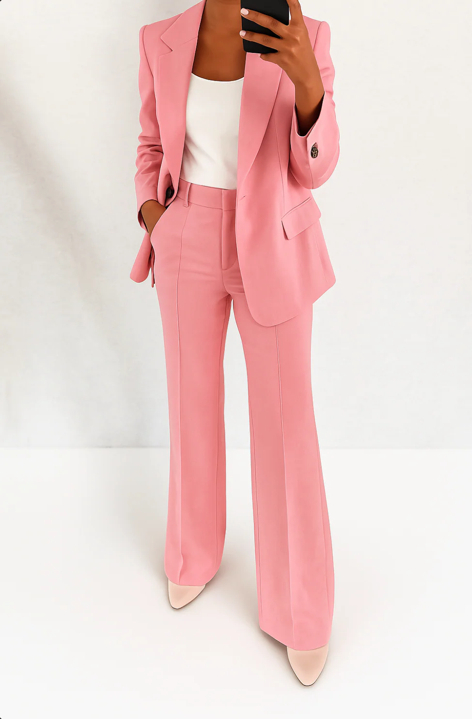 Chic women's two-piece outfit: a fashionable blazer and smart trousers, creating a polished, elegant look.