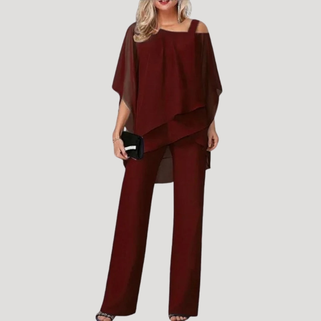 Chic women's two-piece suit: asymmetric top paired with flowing wide-leg trousers for an elegant occasion.