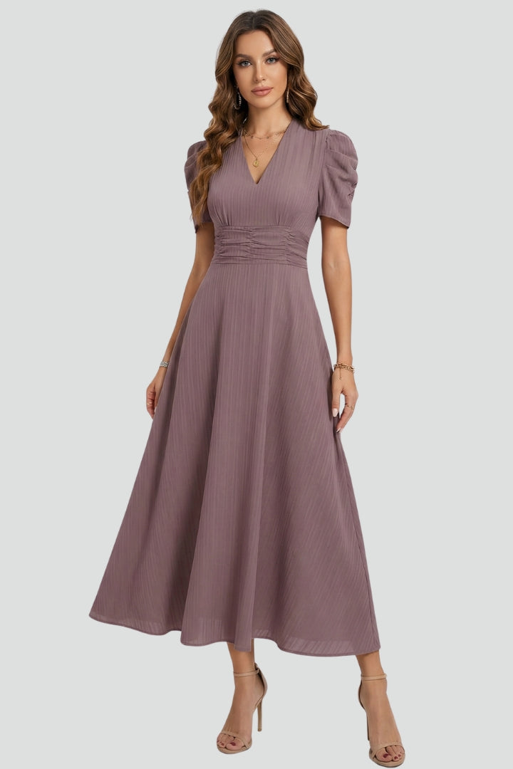 Flowy V-neck midi dress for women featuring short sleeves & a flattering ruched waist, ideal for versatile styling.
