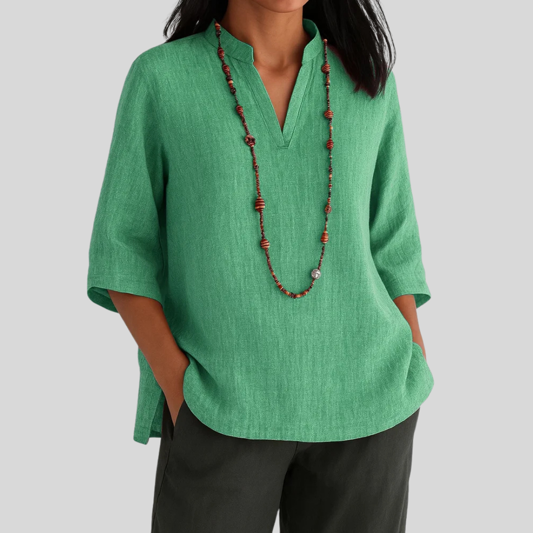 Elegant women's v-notch blouse with three-quarter sleeves & subtle texture, perfect for work or everyday fashion.