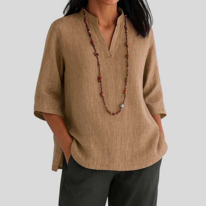 Chic women's v-notch 3/4 sleeve blouse. Elegant textured top, ideal for professional workwear or stylish outings.