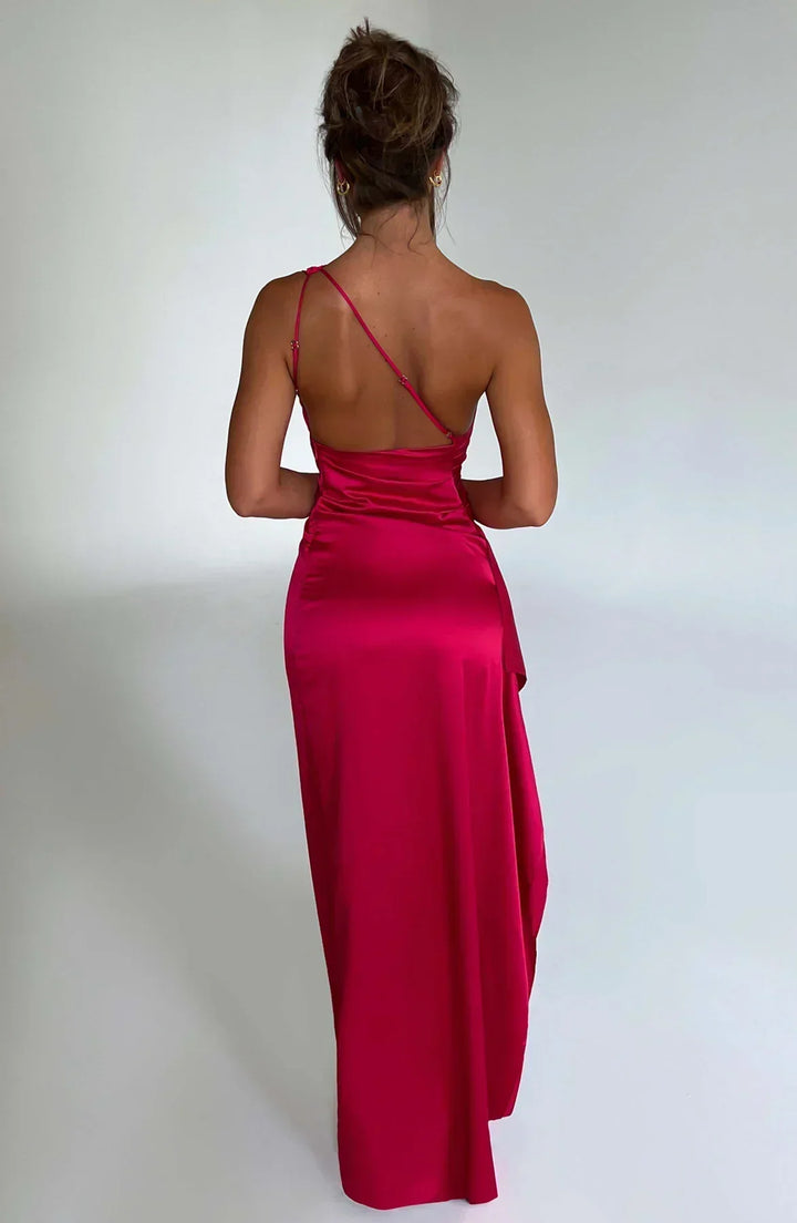 Close-up of the delicate draping on a white one-shoulder maxi dress, highlighting elegant evening wear for women.