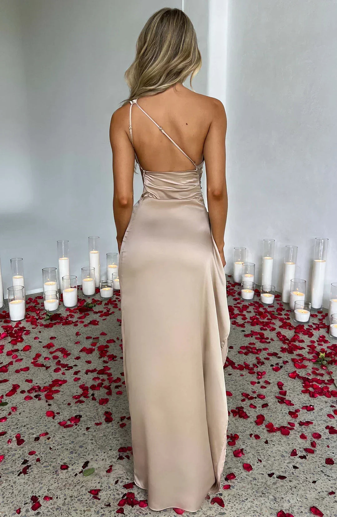 Back view of the white one-shoulder formal maxi dress, emphasizing its draped design and elegant silhouette for women.