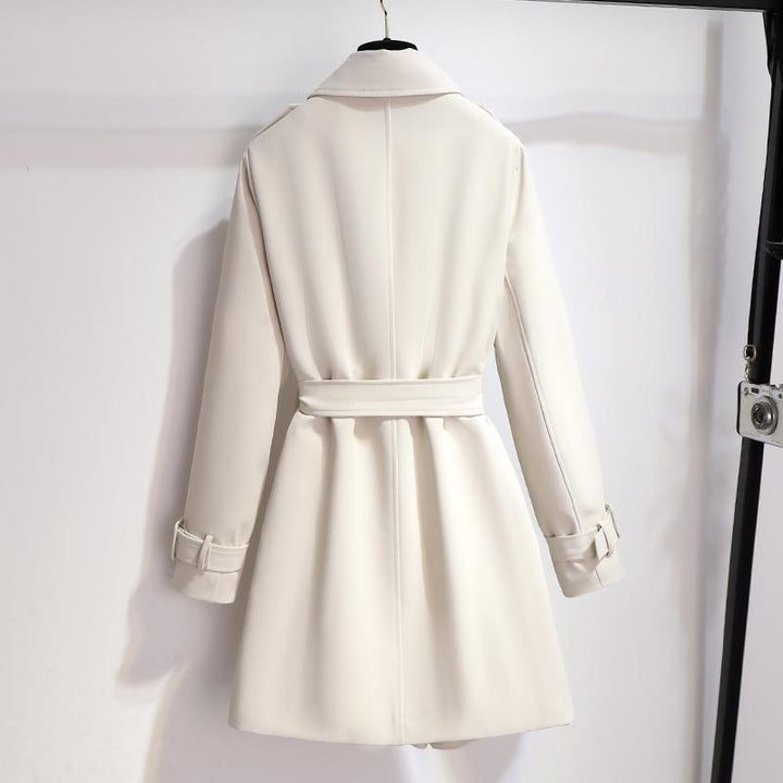 Classic white trench coat for women with a belted waist and sophisticated lapel design, an elegant outerwear piece.