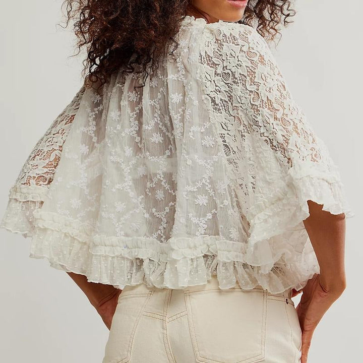 White embroidered lace top for women with elegant ruffles, a versatile and dressy addition to any summer wardrobe