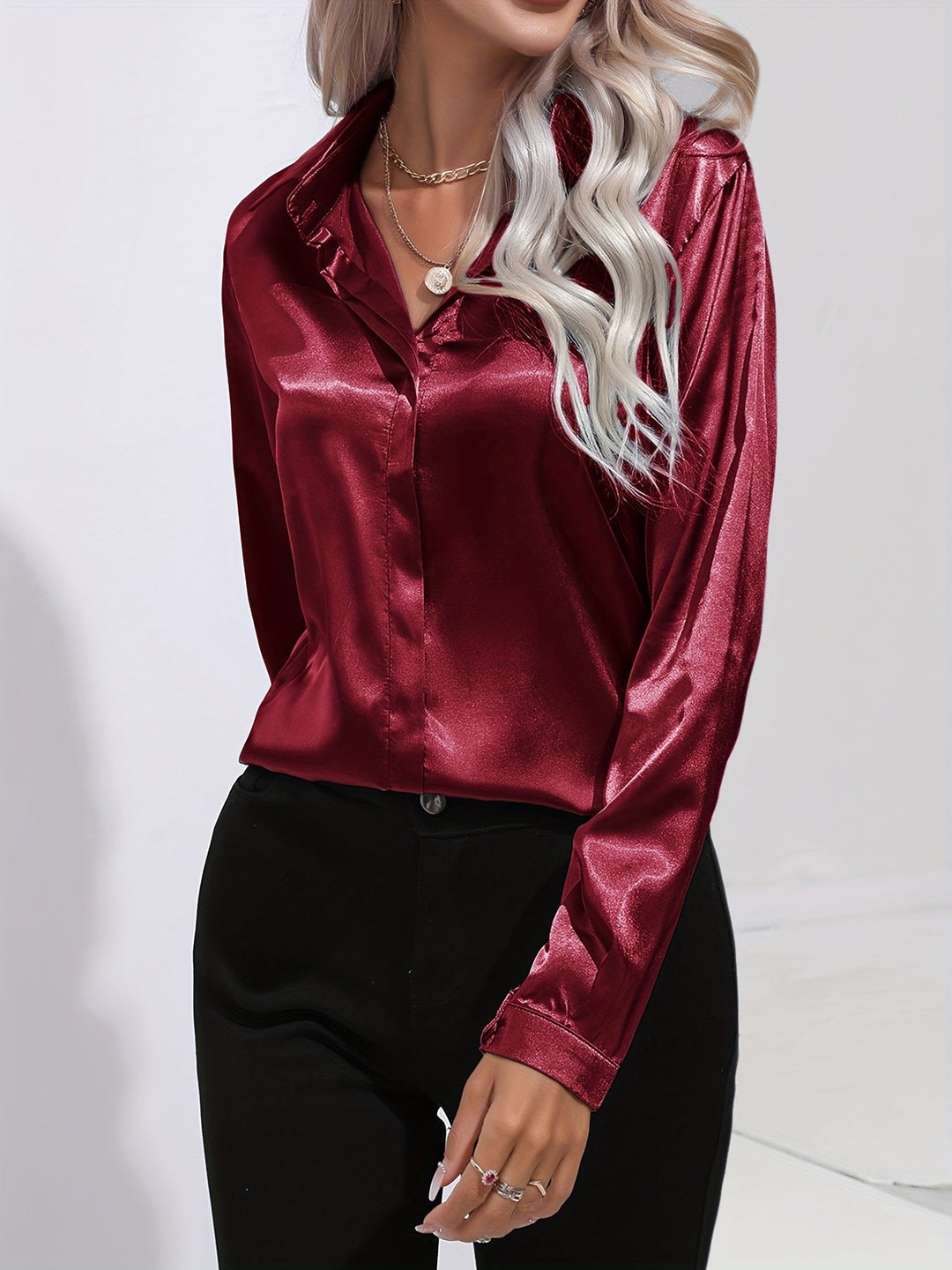 Chic navy blue satin long sleeve blouse, button down style, ideal for a sophisticated women's look.