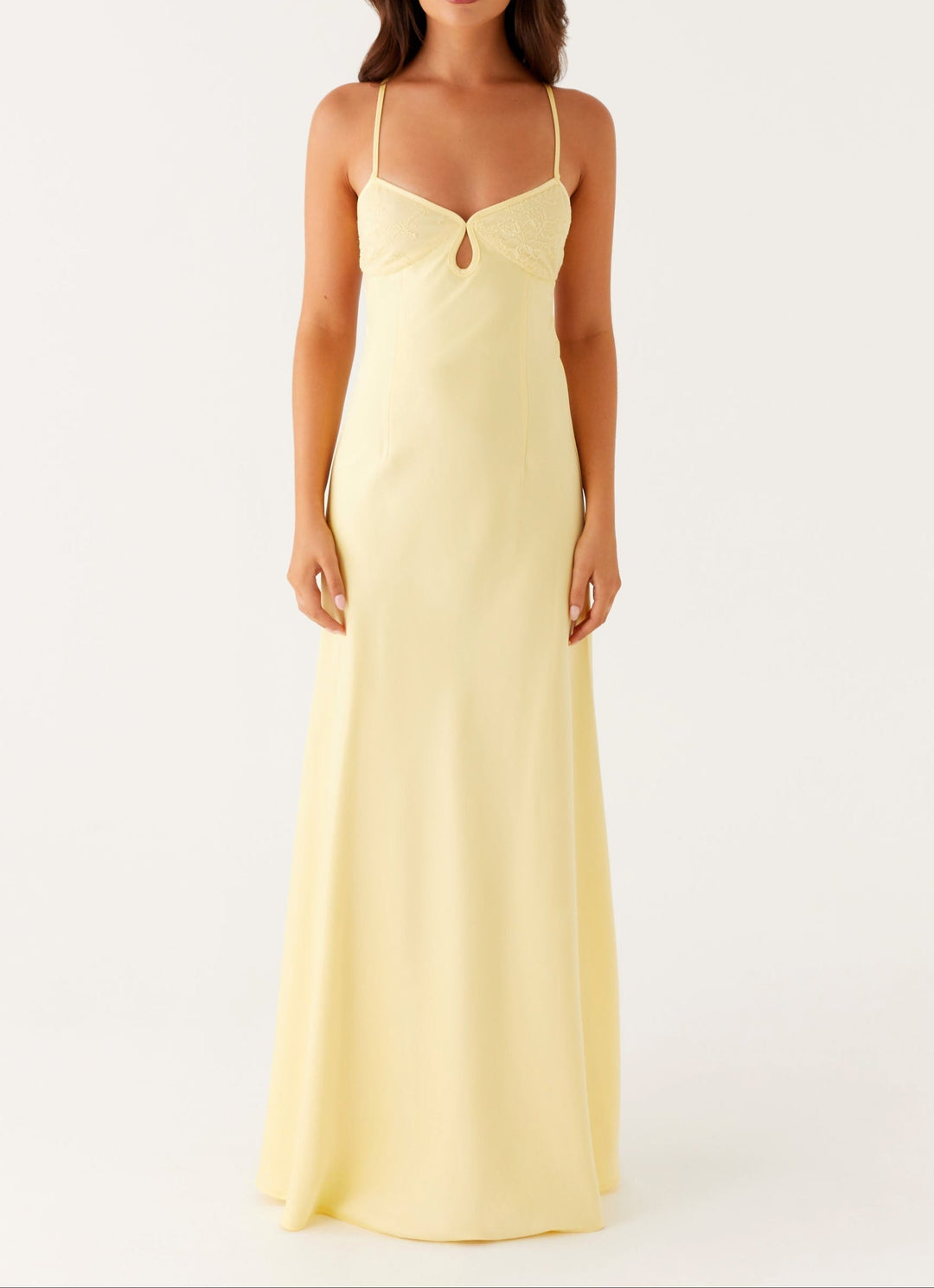 Stylish women's yellow halterneck maxi dress for evening wear. Elegant occasion dress with a flowy skirt.