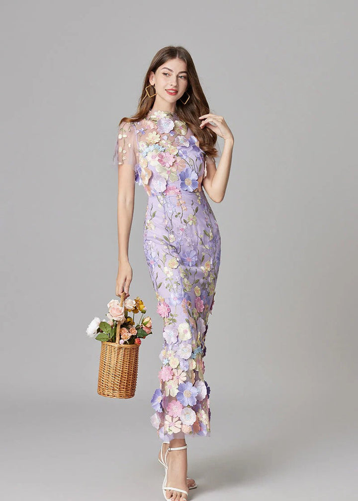 Purple elegant maxi dress, a party-ready gown with sheer fabric and eye-catching 3D floral designs.