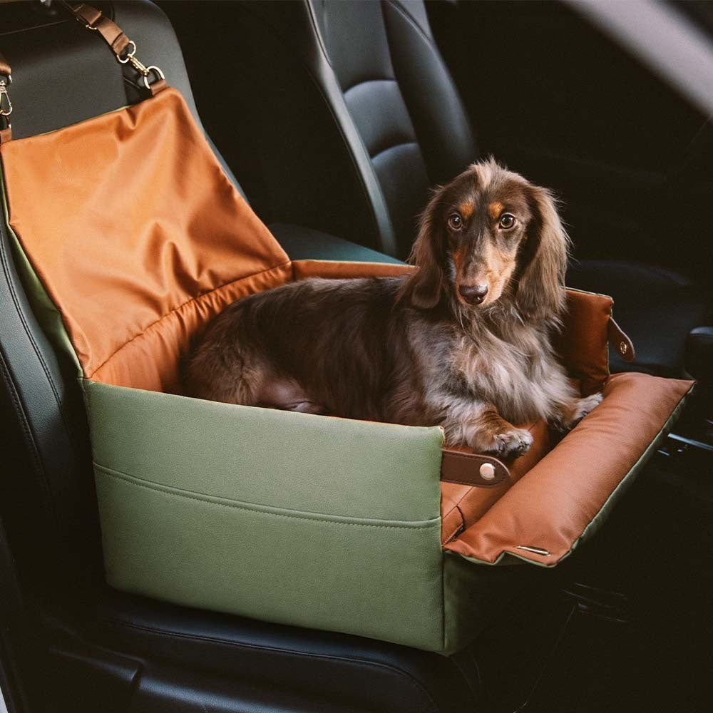 Elevated faux leather dog car seat booster for small pets, ensuring safety and comfort during car travel.