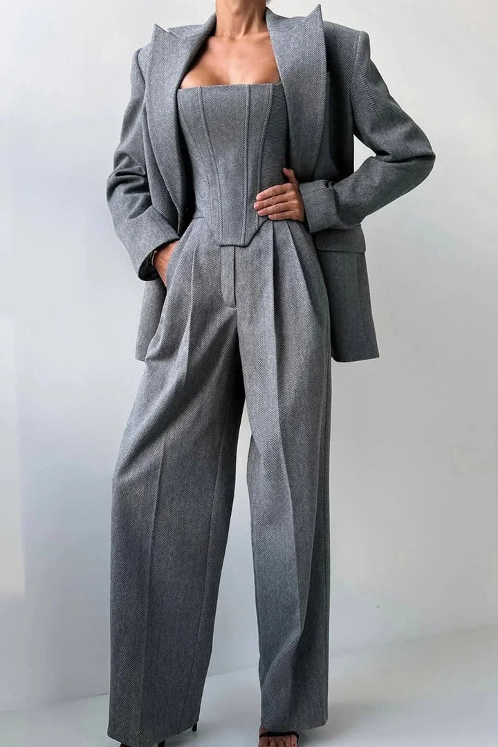 Stylish women's matching set with corset, flowing wide leg pants & modern oversized blazer. Business casual fashion.