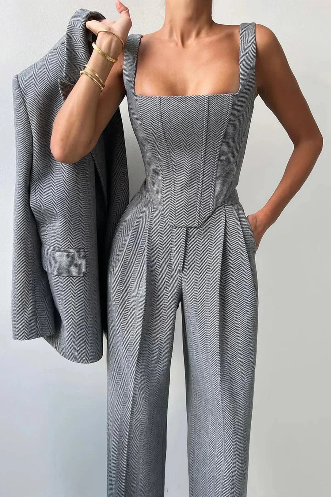Front view of women's sophisticated 3-piece set, featuring a corset top, wide-leg trousers & long blazer.