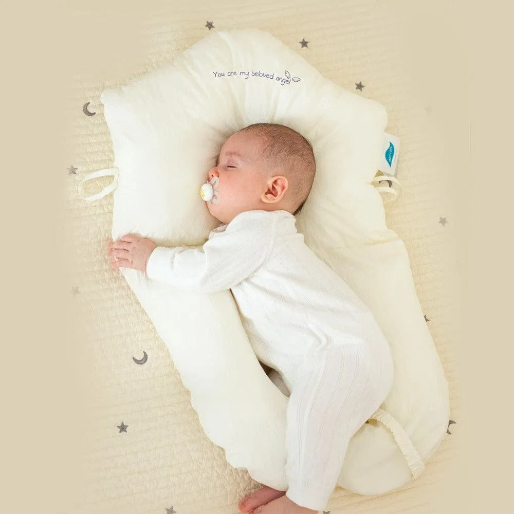 "Ergonomic infant support pillow with adjustable sides, recessed head zone for comfort and alignment, soft exterior, baby-saf
