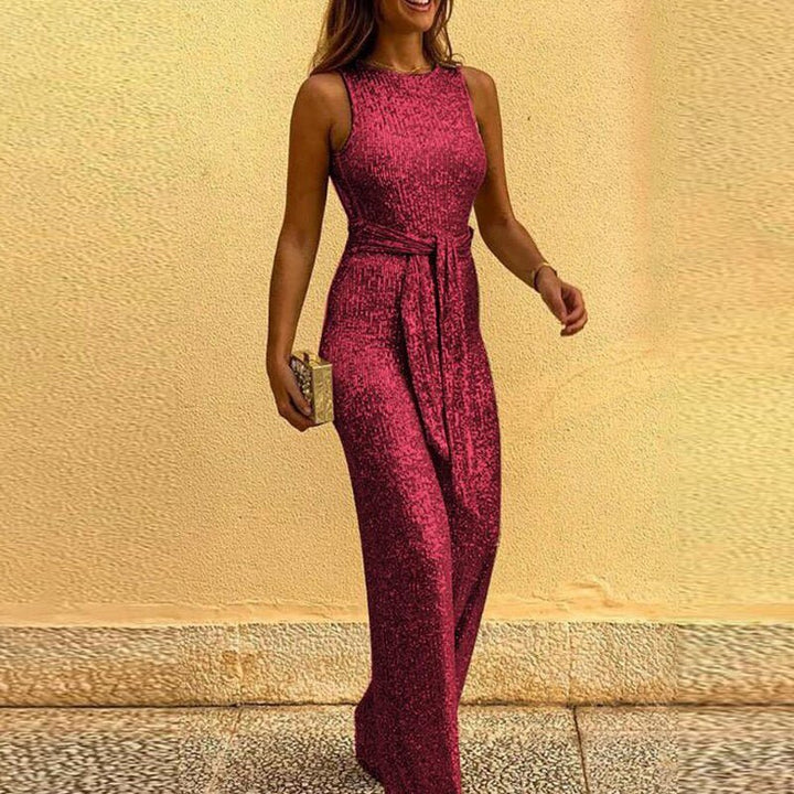 Front view of woman in silver sequin jumpsuit with backless design, perfect for glamorous events.