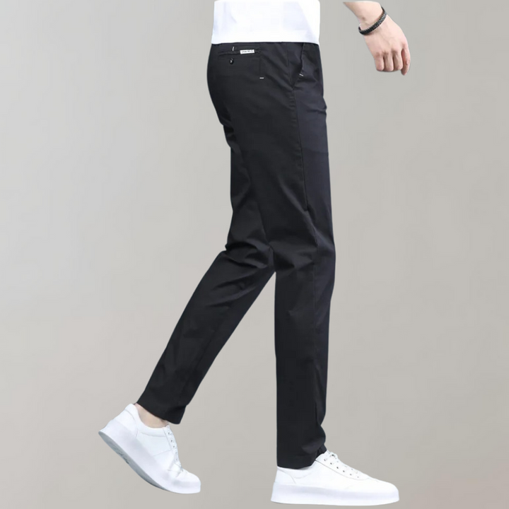 Model wearing men's slim-fit comfortable casual pants paired with a t-shirt, demonstrating casual style.